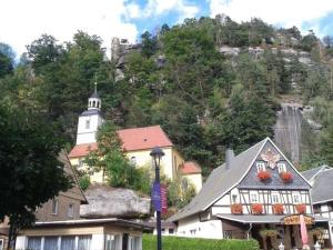 a building in front of a mountain with a church at "Annelies" - barrier-free in Neufriedersdorf