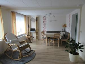 a living room with a table and chairs in it at "Annelies" - barrier-free in Neufriedersdorf