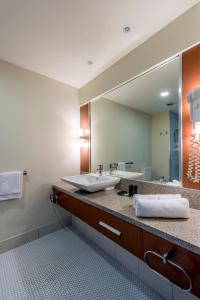 a bathroom with a sink and a mirror at The Colmslie Hotel in Brisbane