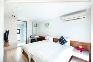 Voodi või voodid majutusasutuse 野居海景渡假民宿Simple Life Home Stay toas