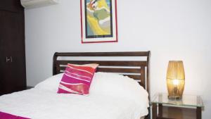 a bedroom with a bed with a pillow and a table at Chefs Delight in San Juan +28 photos