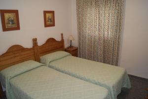 Posteľ alebo postele v izbe v ubytovaní Apartamentos La Dorada