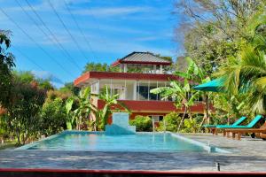 a house with a swimming pool and a resort at Green Hut Nature Resort in Sigiriya