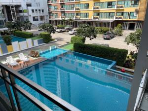 a view of a swimming pool from a balcony of a building at Neo Condo A302 and A303 in Jomtien Beach
