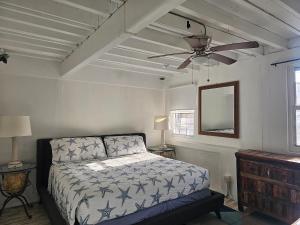 a bedroom with a bed and a ceiling fan at The Landmark St Thomas in Fort Christian