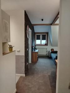 a hallway with a brick wall and a blue couch at Kopaonik Župa 505 in Kopaonik