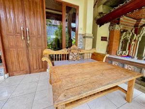 a wooden bench sitting in front of a door at Bagus Homestay in Ubud