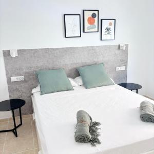 a bedroom with a bed with shoes on it at Magnífico apartamento con vistas en Chayofa! Complejo Mirador del Atlántico in Chayofa +26 photos