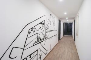a hallway with a drawing on the wall at Townhouse Noida Sector 71 Near ISKCON Temple Noida in Indirapuram