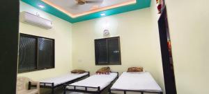 a hospital room with three beds in it at Mallikarjun Residency with AC in Akalkot