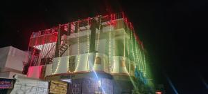 a building with christmas lights on it at night at Mallikarjun Residency with AC in Akalkot +6 photos