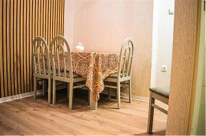 a table with two chairs and a table cloth on it at Ayasofia Suite jakuzzi 2 BedRooms balcony in Thessaloniki