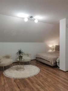 a bedroom with a bed and a table and chairs at Vila Čarna in Međuvršje