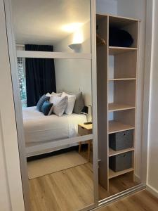 una piccola camera da letto con un letto e uno specchio di St Kilda apt close to beach a Melbourne