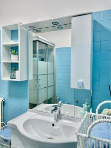 a bathroom with a sink and a mirror at La finestra sul lago in Malgrate +37 photos