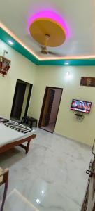 a room with a ceiling with a tv on the wall at Mallikarjun Residency in Akalkot