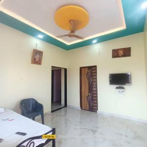 a room with a ceiling with a ceiling fan at Mallikarjun Residency in Akalkot