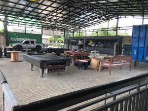 a patio with a ping pong table and benches at Times Square Motel SYARIAH in Bojong