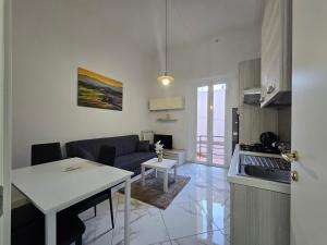 a kitchen and living room with a table and a couch at Affitta camere Tra mari e monti in Cecina
