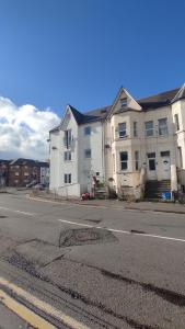 a large white building on the side of a street at CASA JIMENEZ - Close to town with Shared bathroom in Cardiff