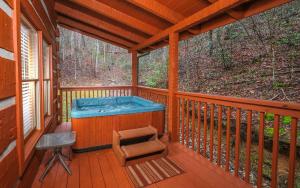 a hot tub on the deck of a cabin at Highland Hideaway in Gatlinburg