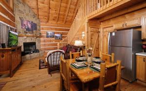 a dining room with a table and a refrigerator at Highland Hideaway in Gatlinburg