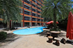 a swimming pool in front of a building at Studio 777 Condo MaiKhao in Ban Mai Salae