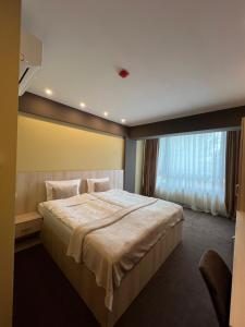 Postel nebo postele na pokoji v ubytování Hotel DAMAD