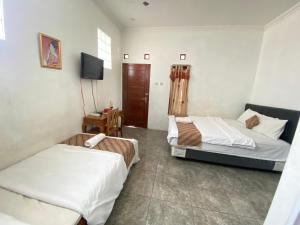 Katil atau katil-katil dalam bilik di Sastro Inn Syariah Hotel Malioboro