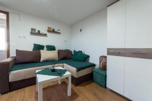 a living room with a couch and a table at Apartmani LUFT in Rača +20 photos