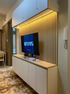 a tv sitting on a counter in a room at Coast Residences condo near MOA, StarCity and PICC in Manila