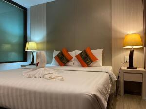 a bedroom with a bed with a towel on it at A Plus Deluxe Hotel in Ko Lipe