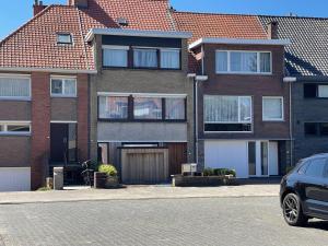 a house with a car parked in front of it at Modern Flat With Garden in Ostend