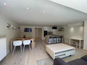 a kitchen and living room with a table and chairs at Modern Flat With Garden in Ostend