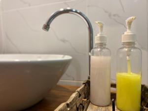 two bottles of soap and a sink in a bathroom at A Plus Deluxe Hotel in Ko Lipe