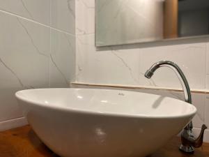 a white sink with a faucet in a bathroom at A Plus Deluxe Hotel in Ko Lipe