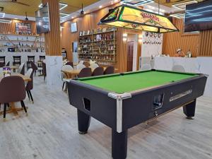 a pool table in a room with a bar at Cave Beach Resort - Boutique Accomodation in Dingalan