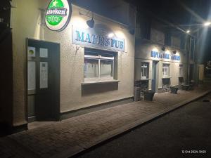 a restaurant with a sign on the side of a building at Matty's Pub - Apartment's in Carlow +31 photos