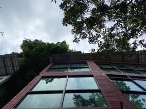 a tall brick building with glass windows at A Plus Deluxe Hotel in Ko Lipe