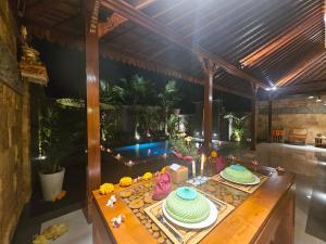 a room with a table with cakes on it at Ubud Paradise Luxury Villa in Ubud