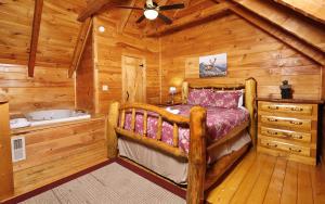 a bedroom with a bed and a tub in a cabin at Highland Hideaway in Gatlinburg +15 photos
