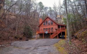 a large wooden house in the middle of the woods at Highland Hideaway in Gatlinburg