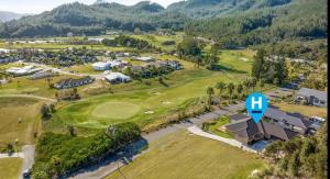 an aerial view of the golf course at a resort at Golf at the beach in Pauanui