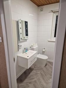 a white bathroom with a sink and a toilet at Catalina - Modern 2 bedroom bungalow in Elgin