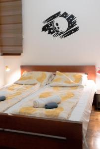 a bed with some pillows on top of it at Konak Apartment in Sarajevo