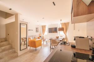 a kitchen and living room with a table and chairs at « L’Observatoire » 6 personnes in Bandol