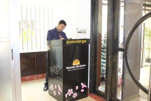 a man standing behind a podium in a building at Nascent Gardenia Baridhara in Dhaka