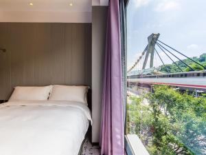 Voodi või voodid majutusasutuse Tango Inn Taipei Jihe toas