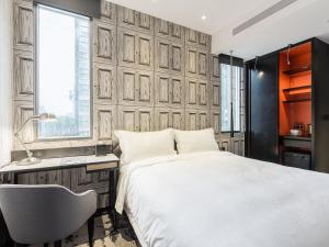 Voodi või voodid majutusasutuse Tango Inn Taipei Jihe toas