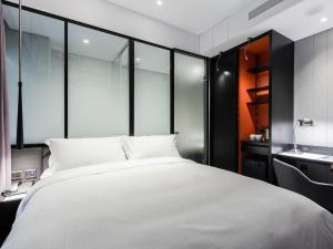 Voodi või voodid majutusasutuse Tango Inn Taipei Jihe toas